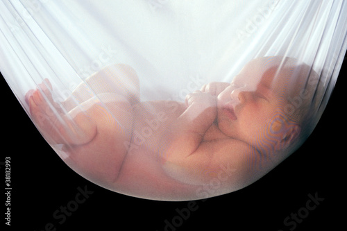 Baby is sleeping in white net hammock