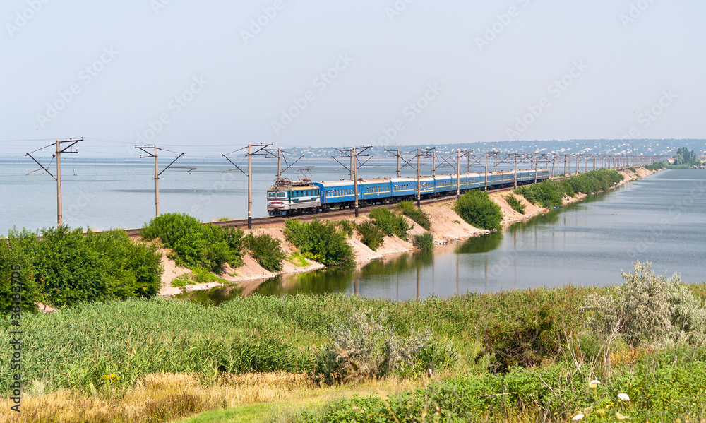 Passenger electric train on a dam