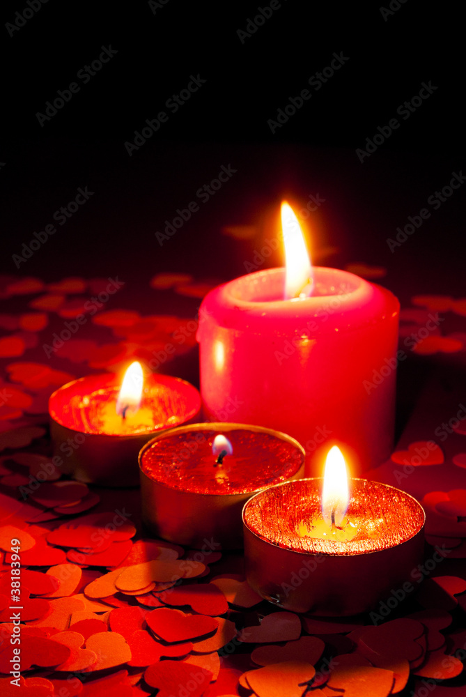 Four burning candles over red background Four burning candles over red background