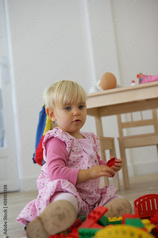 A toddler playing with her toys A toddler playing with her toys