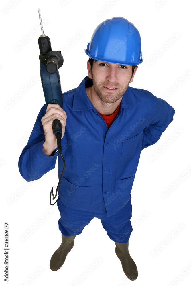 Tradesman holding up an electric screwdriver