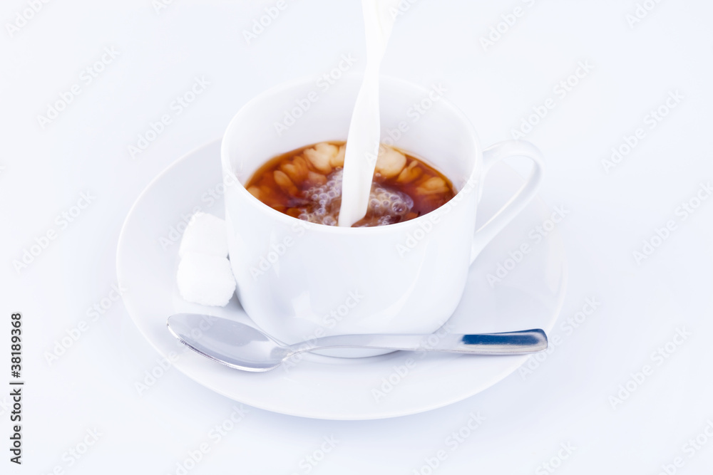 Pouring cream into a cup of coffee Pouring cream into a cup of coffee