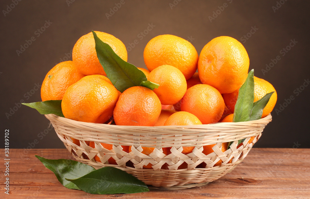 tangerines with leaves in a beautiful basket tangerines with leaves in a beautiful basket