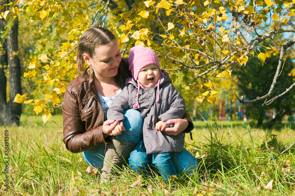 Fototapeta premium The young woman with the daughter on walk