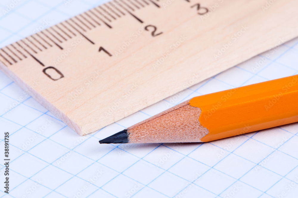 Pencil and ruler on notebook close-up. Pencil and ruler on notebook close-up.