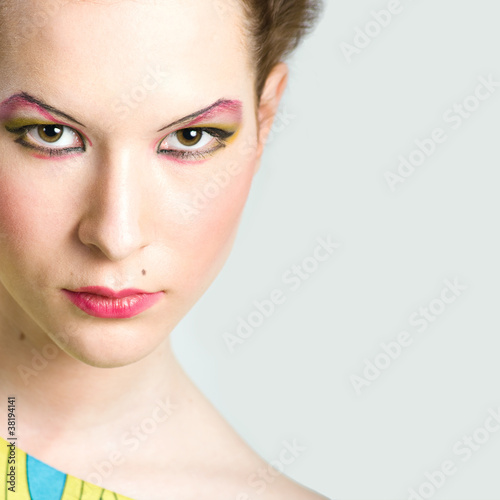 Fashion portrait of young beautiful woman with stylish makeup