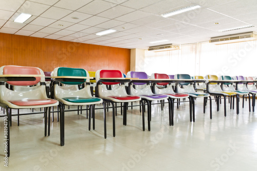 Empty room with many armchairs tilted