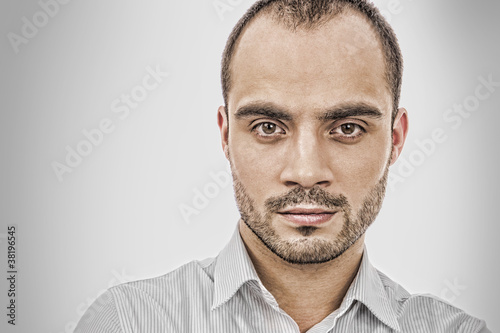 Fashion portrait of adult handsome business man looking at camer