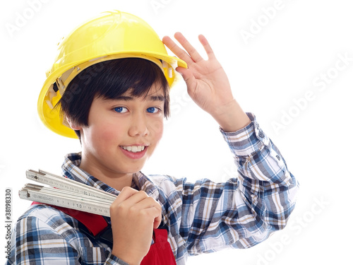 smiling boy wearing construction helmet