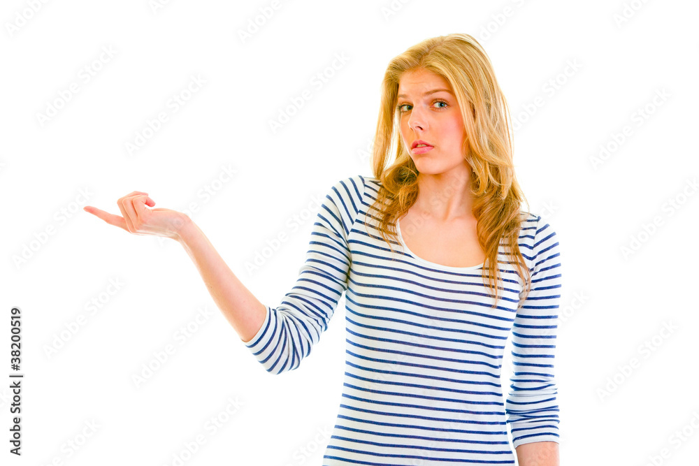 Confused teen girl pointing in corner Confused teen girl pointing in corner