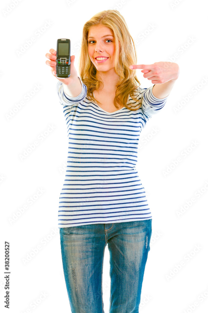 Smiling beautiful teen girl pointing finger on mobile Smiling beautiful teen girl pointing finger on mobile