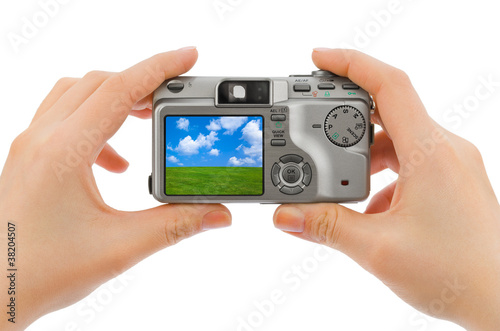 Photo camera in hands and landscape (my photo)