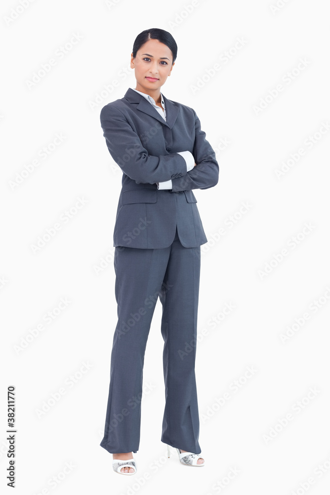 Confident standing businesswoman with arms folded Confident standing businesswoman with arms folded