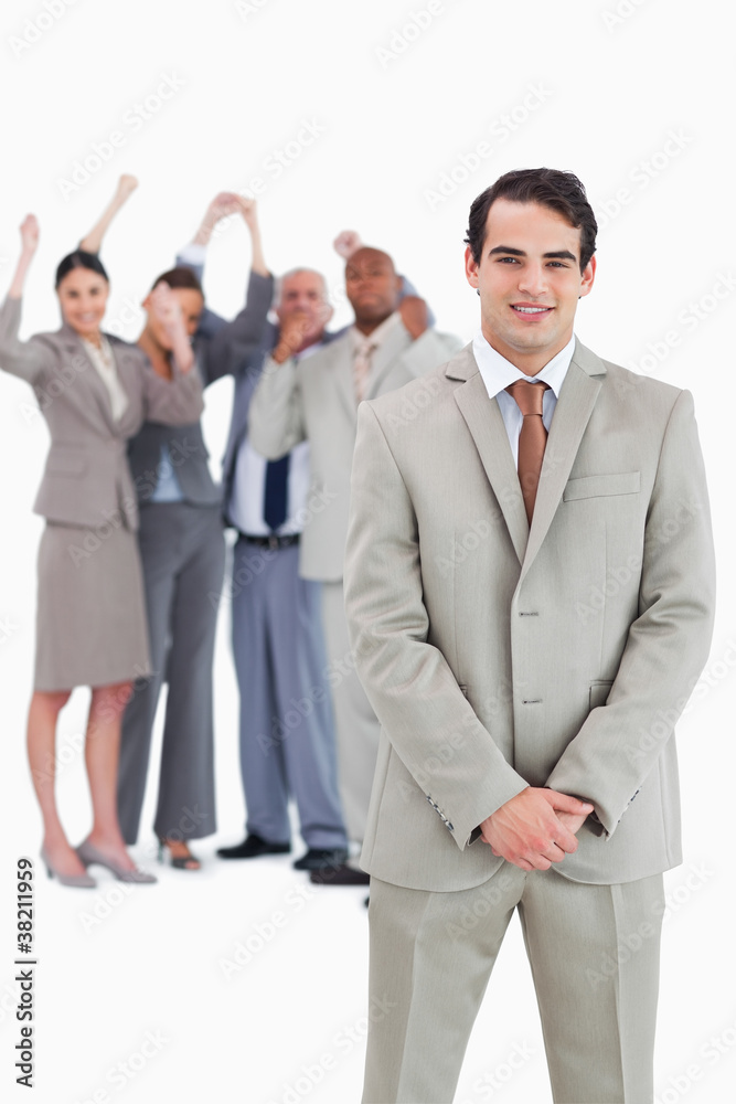 Businessman with cheering team behind him Businessman with cheering team behind him