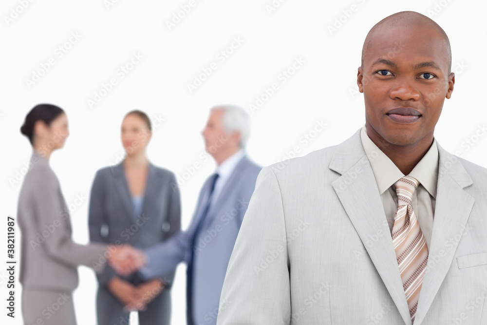 Businessman with trading partners behind him Businessman with trading partners behind him