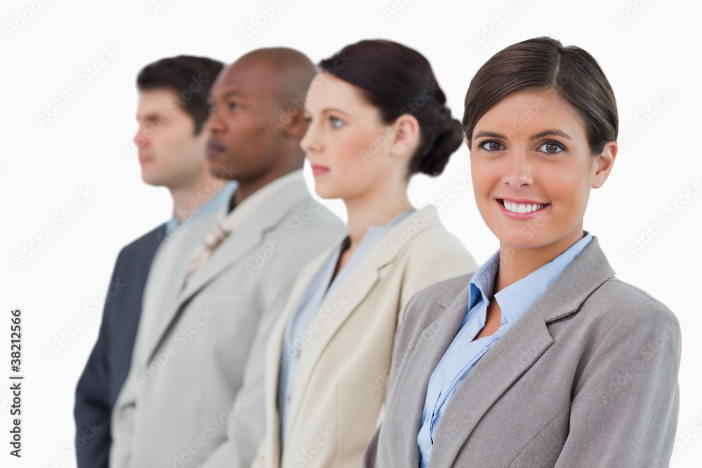 Smiling saleswoman standing next to her associates Smiling saleswoman standing next to her associates