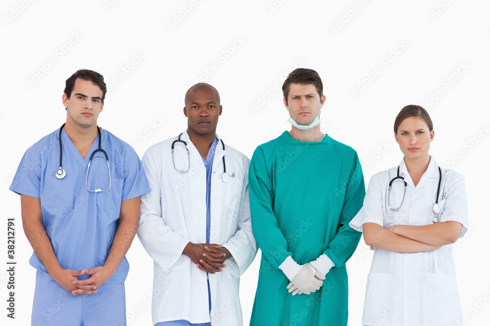 Serious looking medical team standing together Serious looking medical team standing together