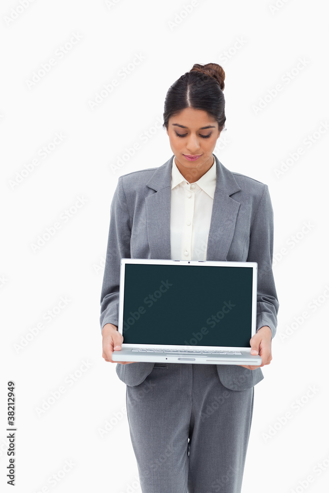Businesswoman looking at laptop in her hands