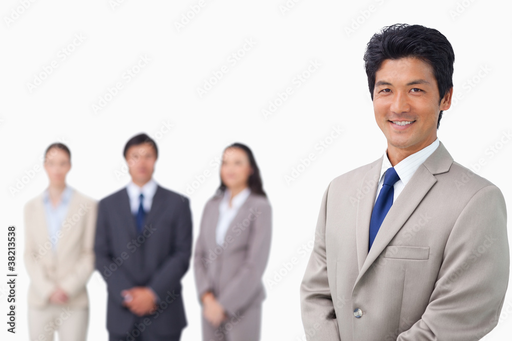 Businessman standing with his team behind him Businessman standing with his team behind him