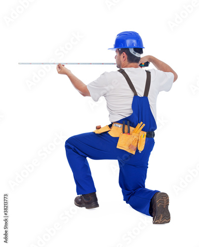 Worker measuring with tape