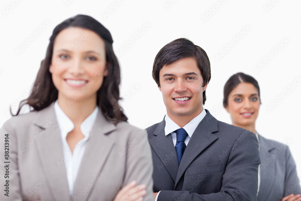 Smiling young businesspeople with arms folded Smiling young businesspeople with arms folded