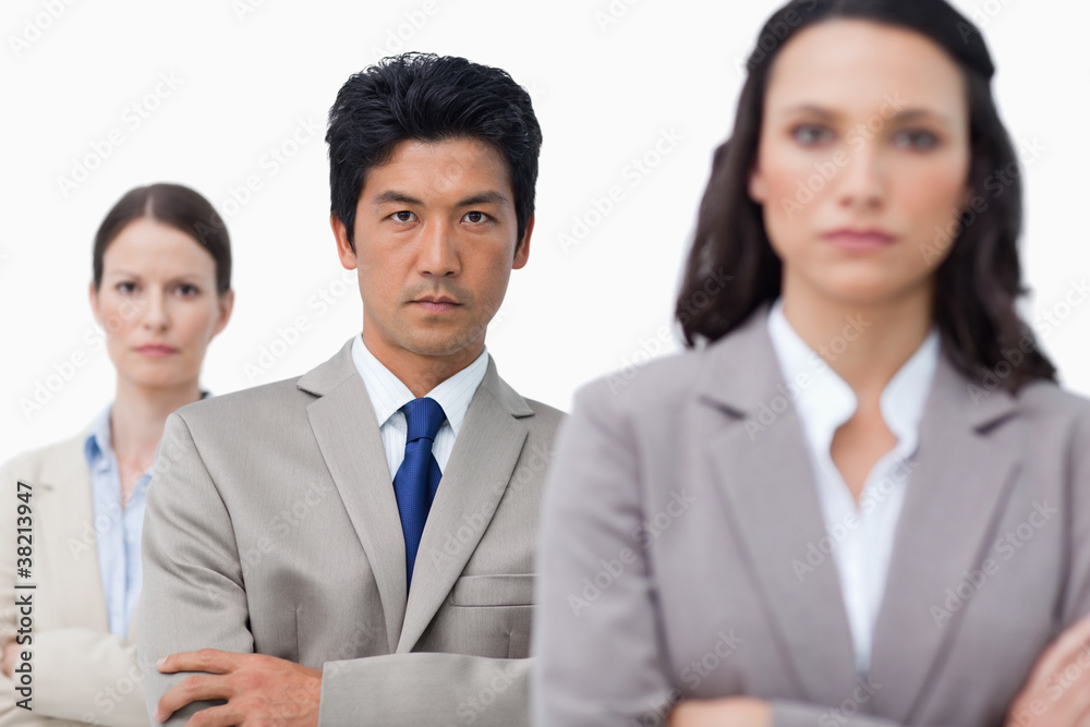 Serious salesteam with folded arms Serious salesteam with folded arms