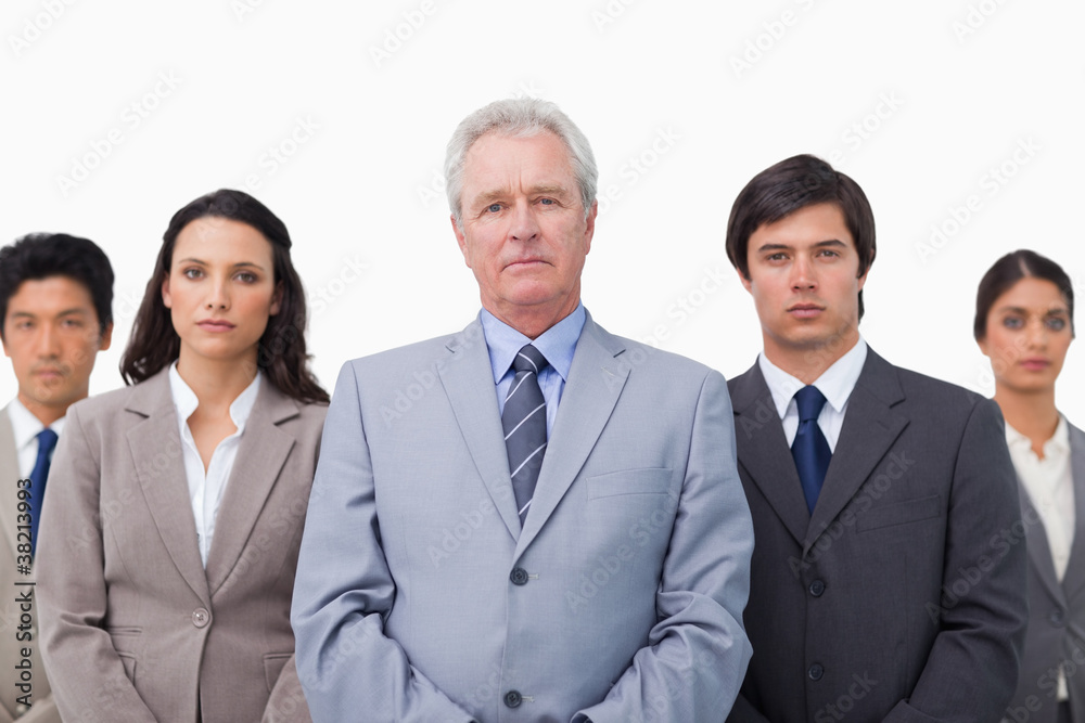 Mature businessman standing with his team Mature businessman standing with his team
