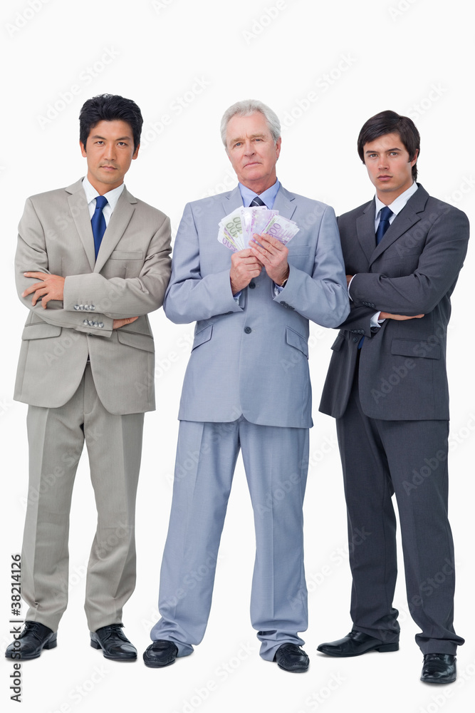 Senior salesman with money and his employees Senior salesman with money and his employees