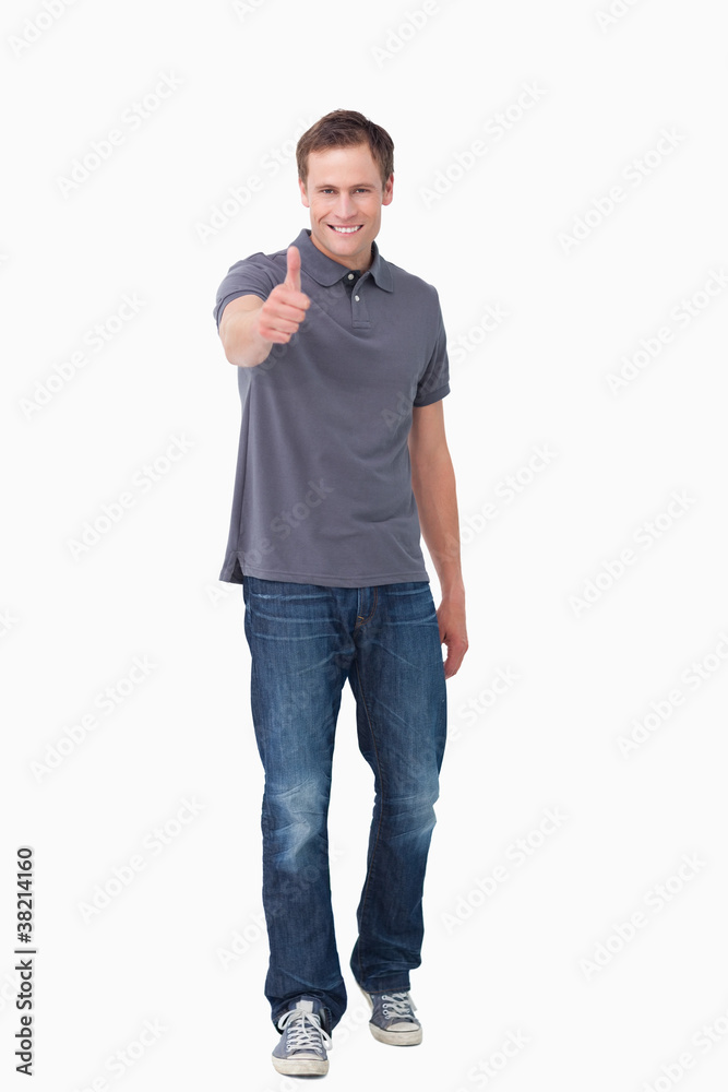 Smiling young man giving thumb up Smiling young man giving thumb up