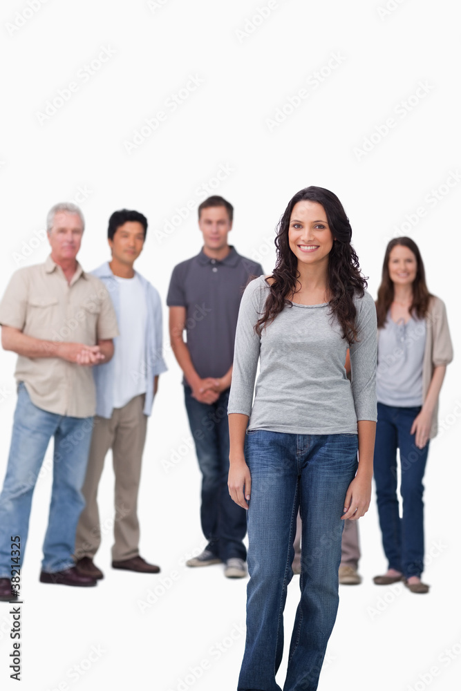 Smiling woman standing with friends behind her Smiling woman standing with friends behind her