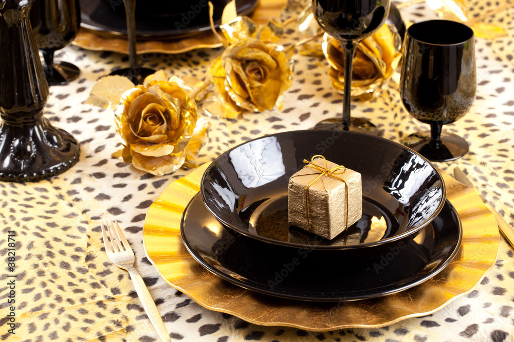 Black and gold place setting and gift box