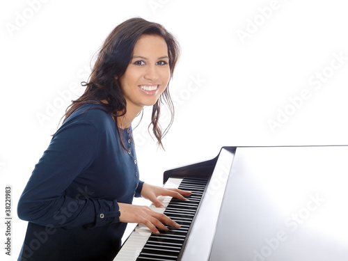 smiling teenage girl playing piano