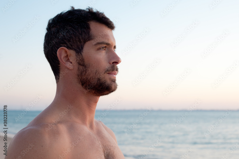 Handsome muscular man on the beach. Handsome muscular man on the beach.