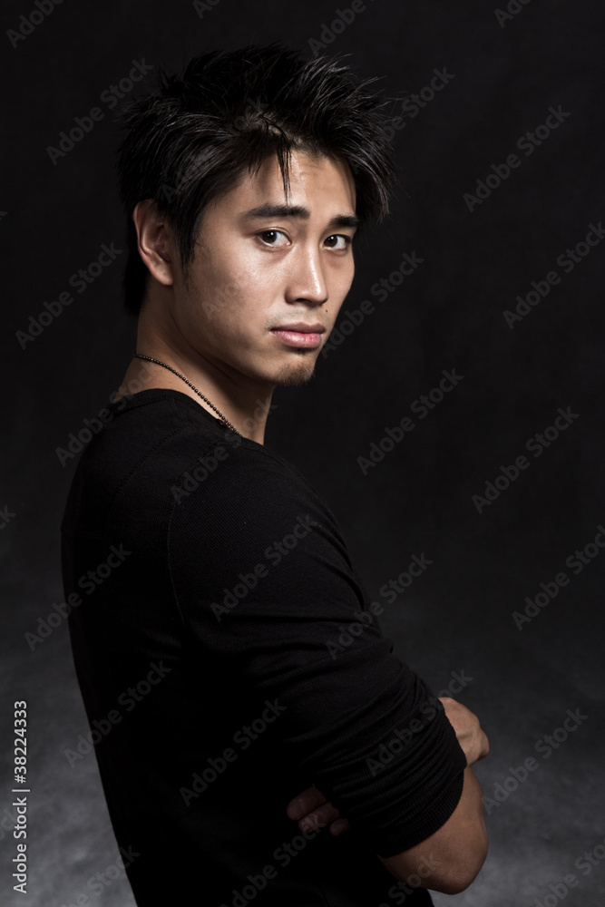 Handsome asian american fashionable man in black
