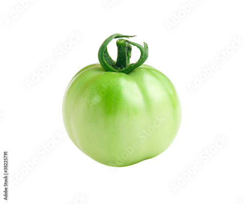 An unripe green tomato isolated on a pure white background.