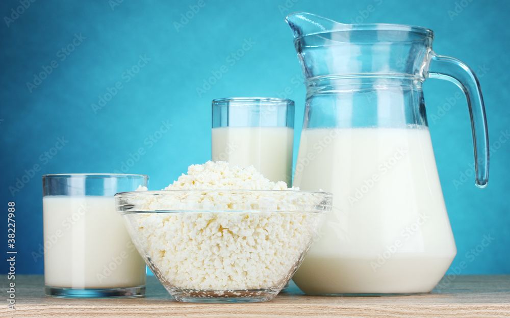 Dairy products on wooden table on blue background Dairy products on wooden table on blue background