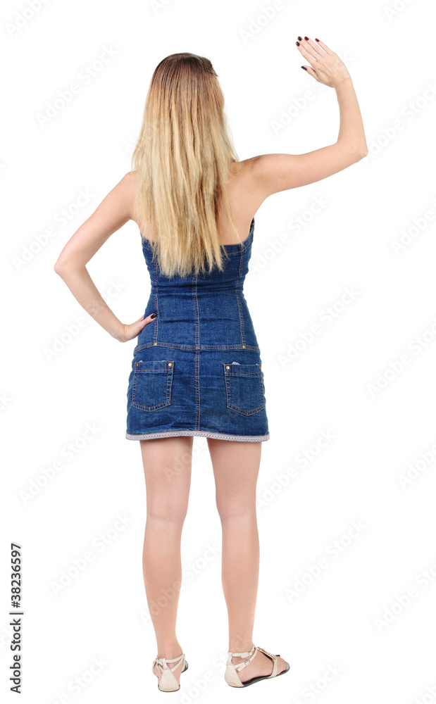 back of view beautiful young woman in jeans dress pointing at w back of view beautiful young woman in jeans dress pointing at w