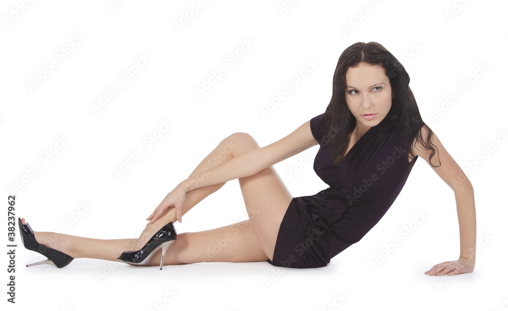 Lovely young lady in black dress lying isolated white background Lovely young lady in black dress lying isolated white background