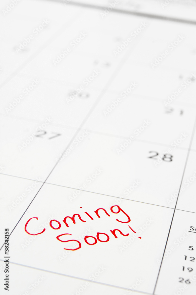 Macro of calendar with red Coming Soon text Macro of calendar with red Coming Soon text