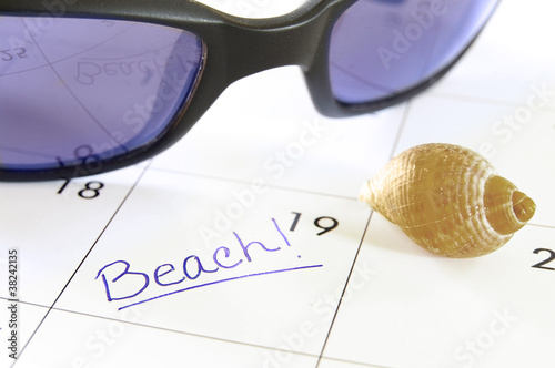 Closeup of a calendar with Beach text photo