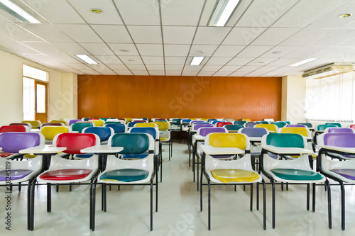 Empty room with many armchairs ront