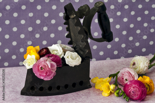 old iron stuffed with spring flowers photo