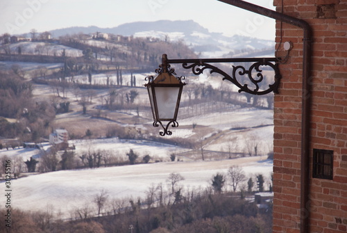 Street lamp and winter landscape, Sarnano, Italy photo