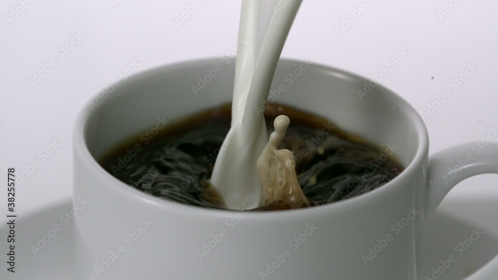 Pouring milk into cup of coffee, Slow Motion Pouring milk into cup of coffee, Slow Motion