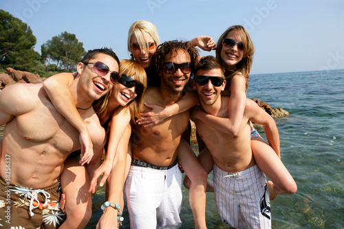 Group of young friends having fun at the seaside