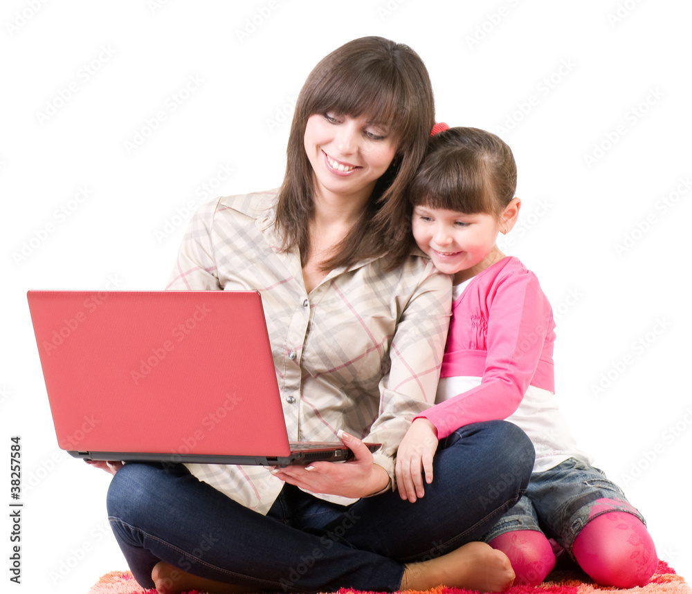 Happy family, mother and her little daughter with laptop Happy family, mother and her little daughter with laptop