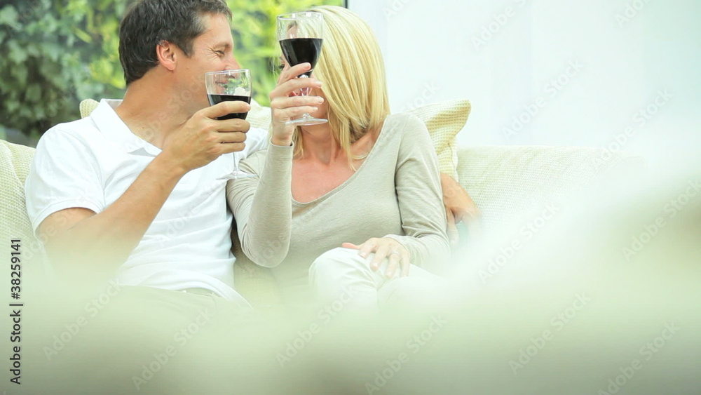 Attractive Couple Relaxing at Home Drinking Wine Attractive Couple Relaxing at Home Drinking Wine