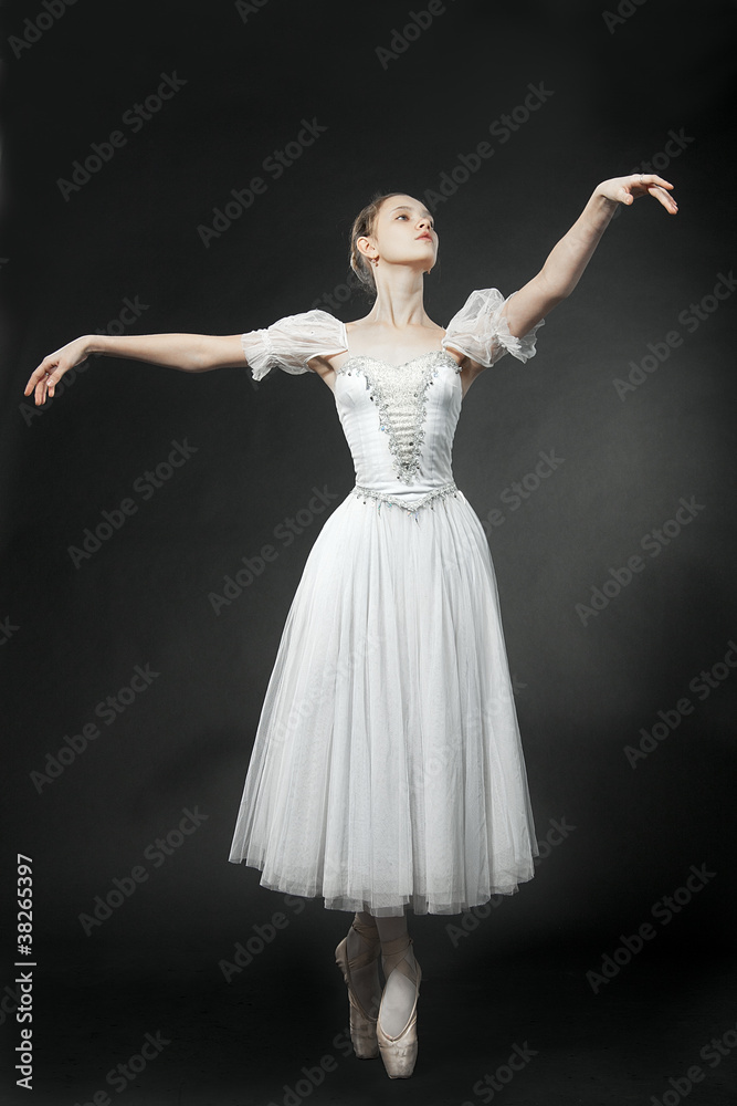 Beautiful dancer posing on studio background