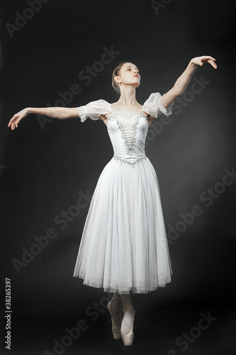 Beautiful dancer posing on studio background