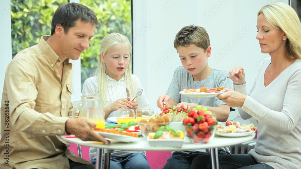Young Caucasian Family Sharing Healthy Lunch Together Young Caucasian Family Sharing Healthy Lunch Together
